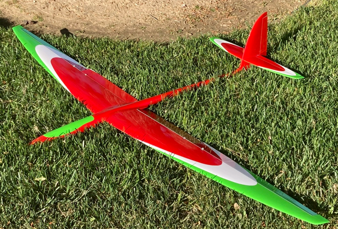 Model glider planes on grass field